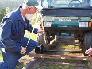 a man working on electric hyrailer motorcar