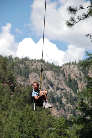 a man flying a kite in a forest