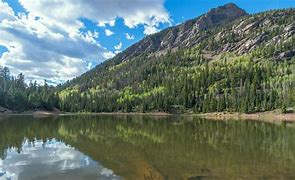 a body of water with a mountain in the background