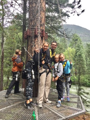 a group of people standing next to a tree