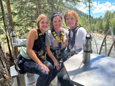 Three generations enjoying ziplining and taking in the view at Soaring's riverside lunch platform.